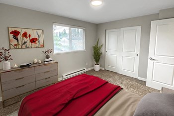Bedroom Bedroom with gray carpet, double sliding door closet, large window with blinds staged with dresser, wall art, a bed, and plant. - Photo Gallery 2