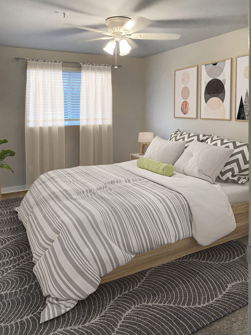 Bedroom Bedroom with large window, blinds, and ceiling fan. Staged with a queen-size bed, side tables, a house plant, and wall art.at Sitka Heights, Fife, 98424
