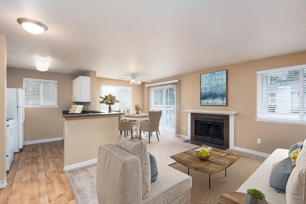 a living room with a fireplace and a dining room and kitchen