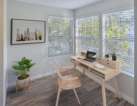 Room stage with office furniture. Three large windows let in a lot of natural light. Area has hard wood style flooring.at Edmonds Gateway, Edmonds, WA
