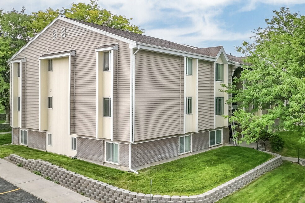 a grey and with a yard and a sidewalk  at Summit, Pocatello, ID