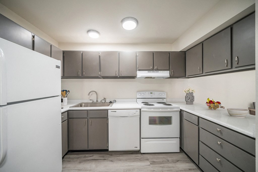 a kitchen with white appliances and gray cabinets at Summit, Pocatello Idaho