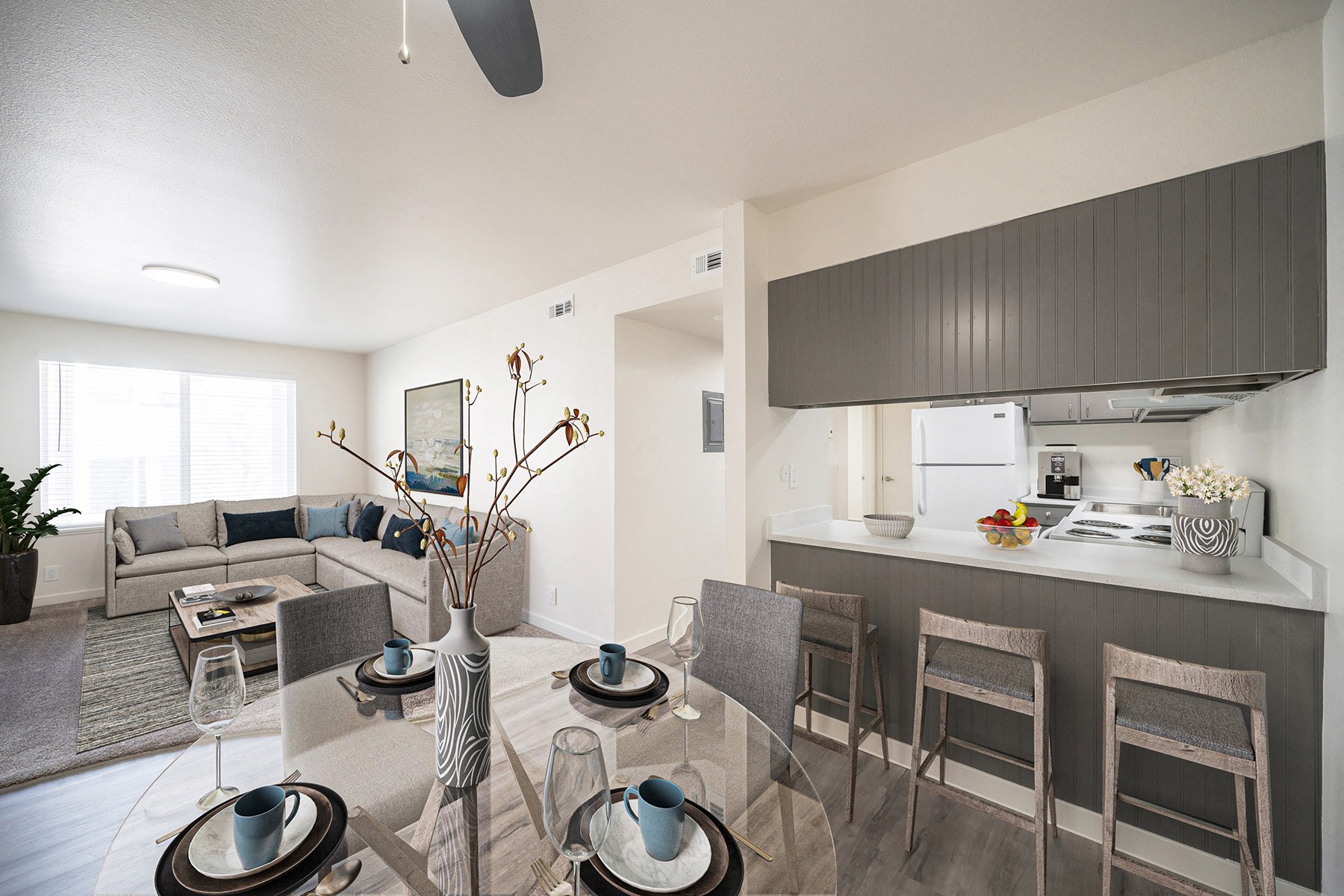 a living room and dining room with a table and chairs