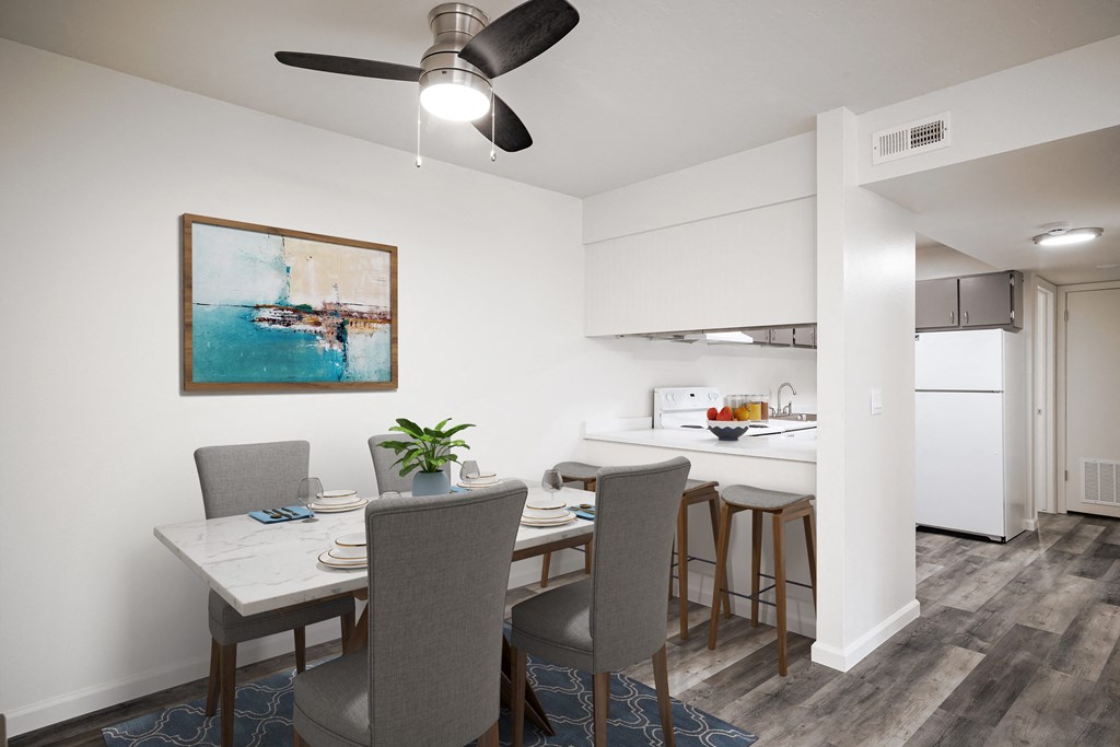a dining room and kitchen with a table and chairs