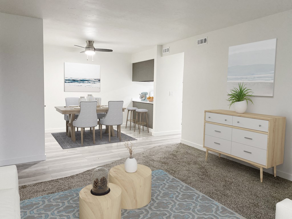 Living room opens into the dining area with a ceiling fan and breakfast bar on the right. Staged with dining set and wall art.at Summit, Idaho, 83201