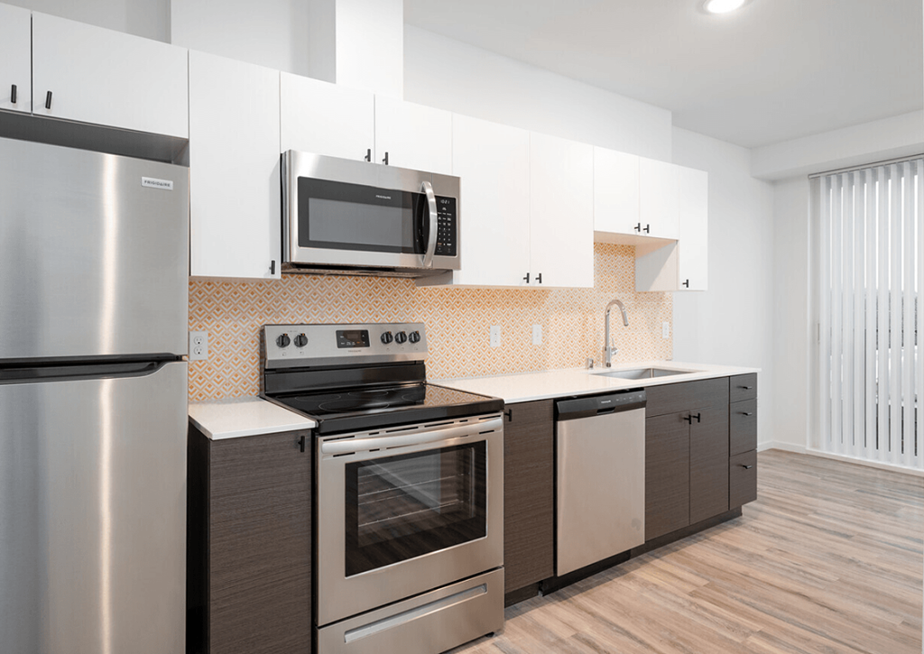 a kitchen with stainless steel appliances and white cabinets