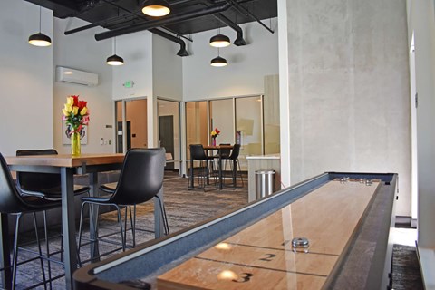 Resident lounge with shuffleboard at The Duo Apartments in University Place, WA.