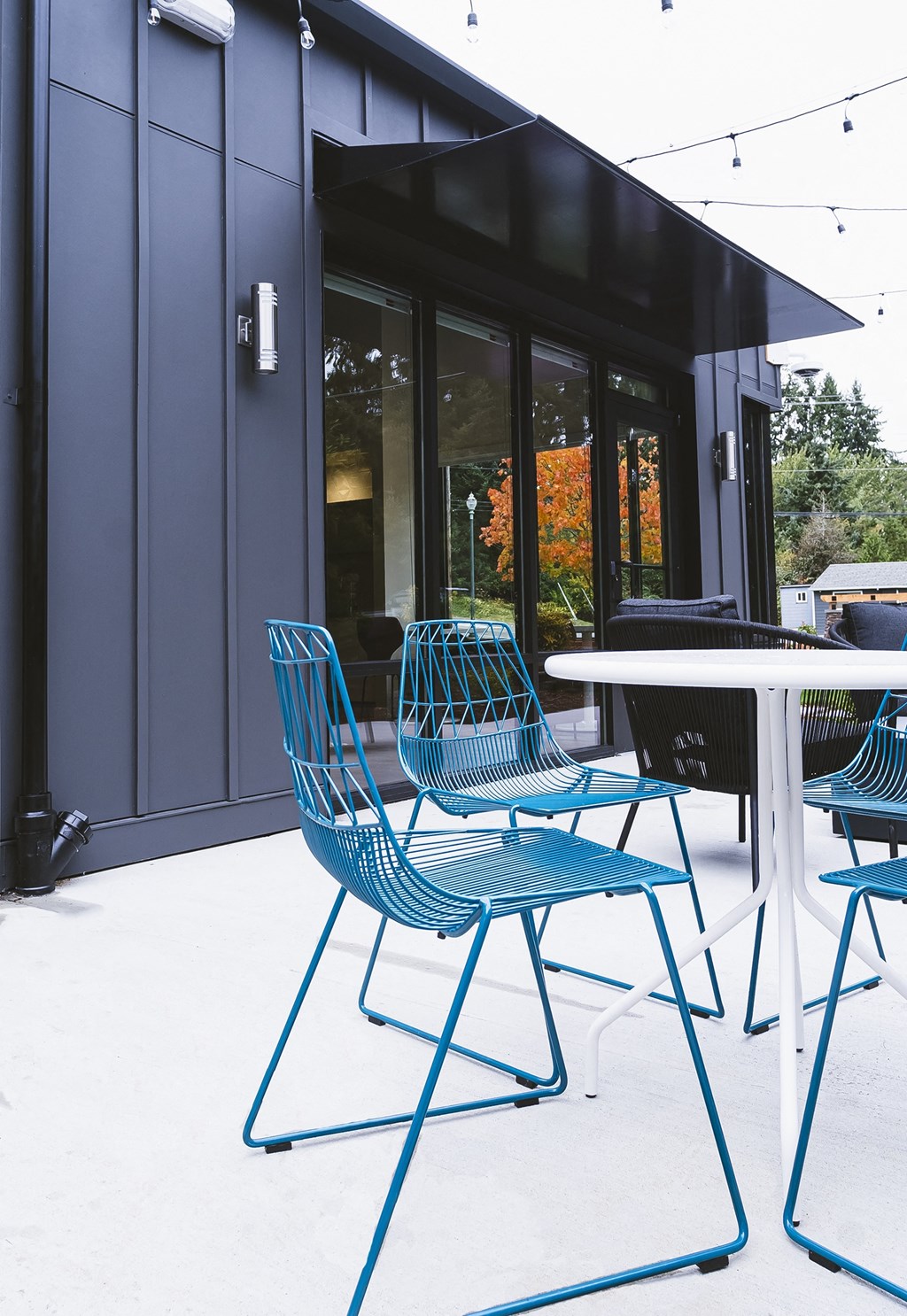 Outdoor lounge with seating area and access to the clubhouse at University Glen, Washington