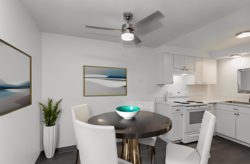 a kitchen and dining room with white appliances and a table and chairs