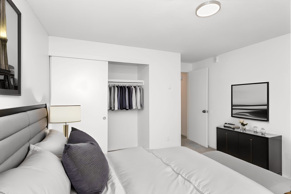 a bedroom with a large bed and a closet