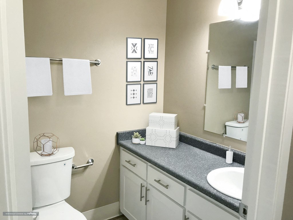 a bathroom with a toilet and a sink and a mirror at Woodland Crossing , Woodland, CA 95695