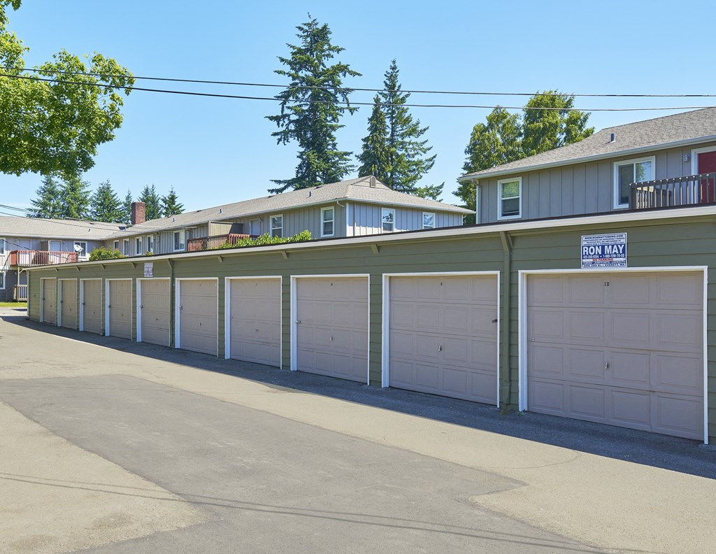 a row of garages with white garage doors in front of houses  at Woodhaven, Everett, WA