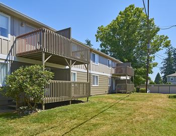 a row of houses with balconies on the side of a yard  at Woodhaven, Washington