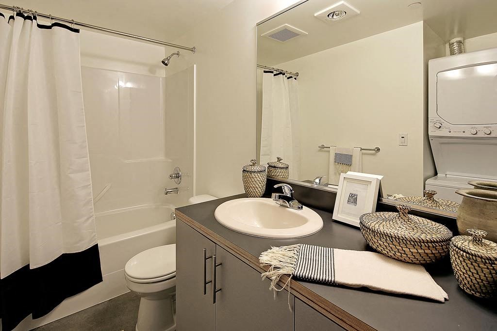 Bathroom with vanity and sink, toilet, and bath/shower combination.at 19th & Mercer, Seattle Washington