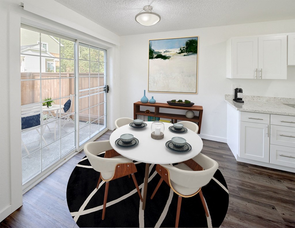 an open kitchen and dining room with a white table and chairs at Woodcreek, Poulsbo, 98370