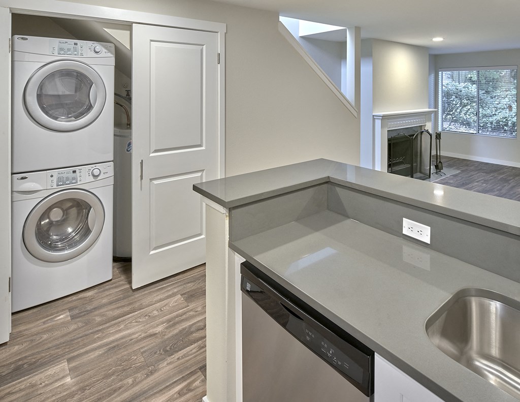 Kitchen looking into double door closet with stacked washer and dryer.at Edmonds Gateway, Edmonds, 98026