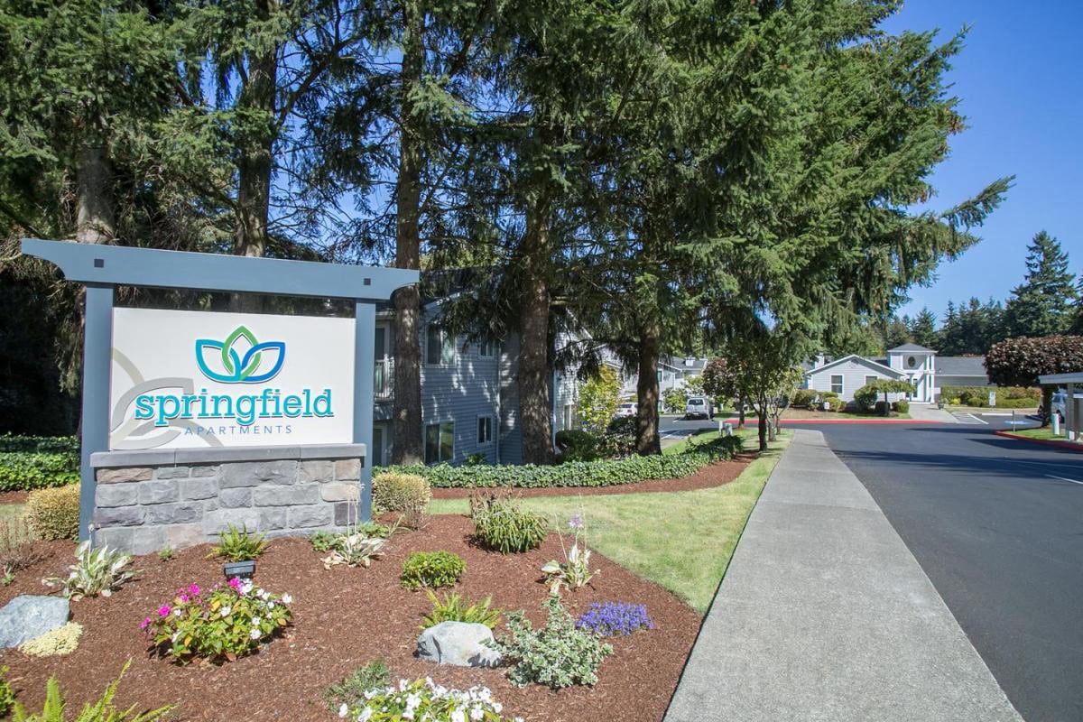 Exterior entry with trees and other plants.  There is a Springfield welcome sign.at Springfield, Renton, WA