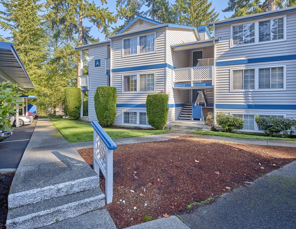 a blue and white house with a sidewalk in front of it  at Edmonds Gateway, Washington