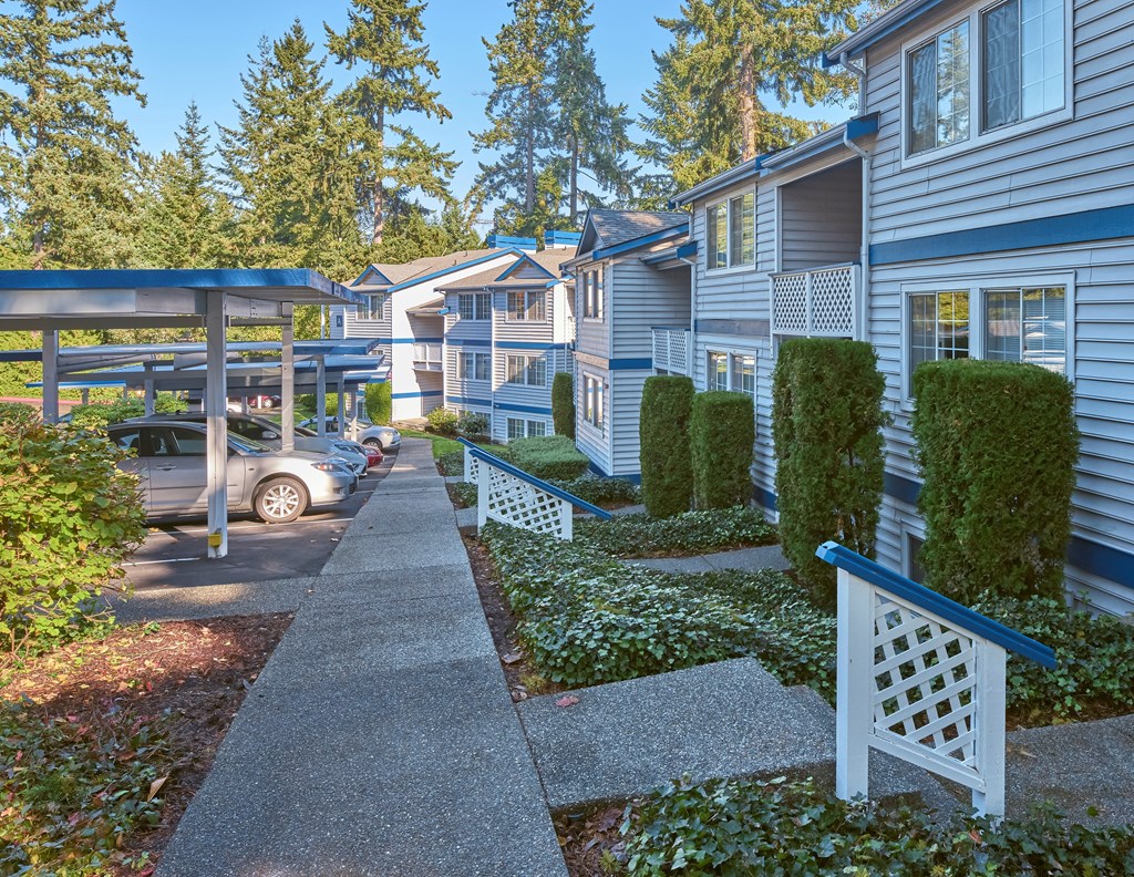 a row of townhomes with blue siding and white trim at Edmonds Gateway, Bremerton