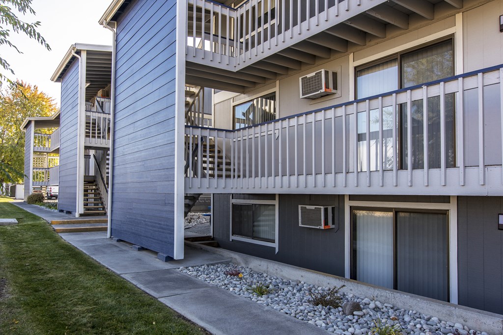 Exterior view of rock path and buildings at The Lakes Apartments, Moses Lake, WA.