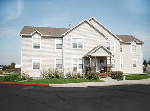 A two-story house with a red line in front of it.