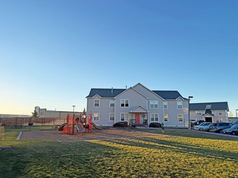 A large house with a playground in front.