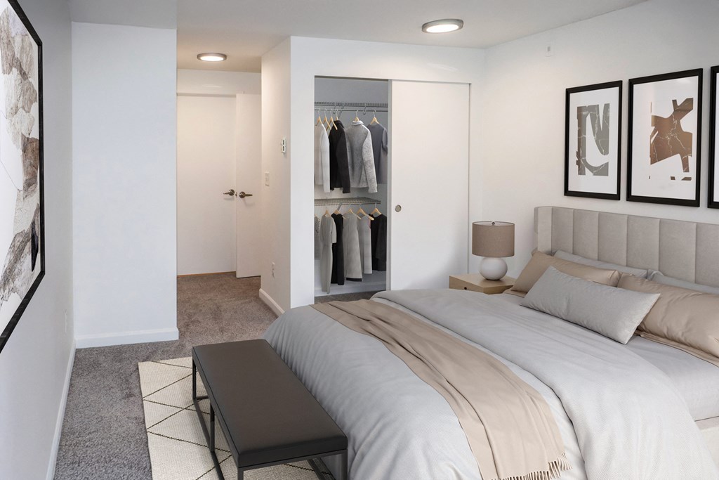 A bedroom with a large bed and a walk-in closet at Heritage Grove in Renton.