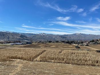 a harvested field with mountains in the background at Altitude, East Wenatchee, WA, 98802