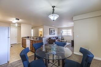 Dining area with round table that is open to kitchen and living room. - Photo Gallery 2