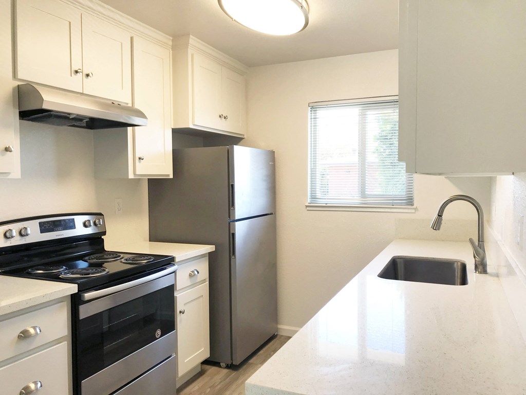 a kitchen with stainless steel appliances and a white counter top at Ella 1711 Apartments, Woodland, CA 95695