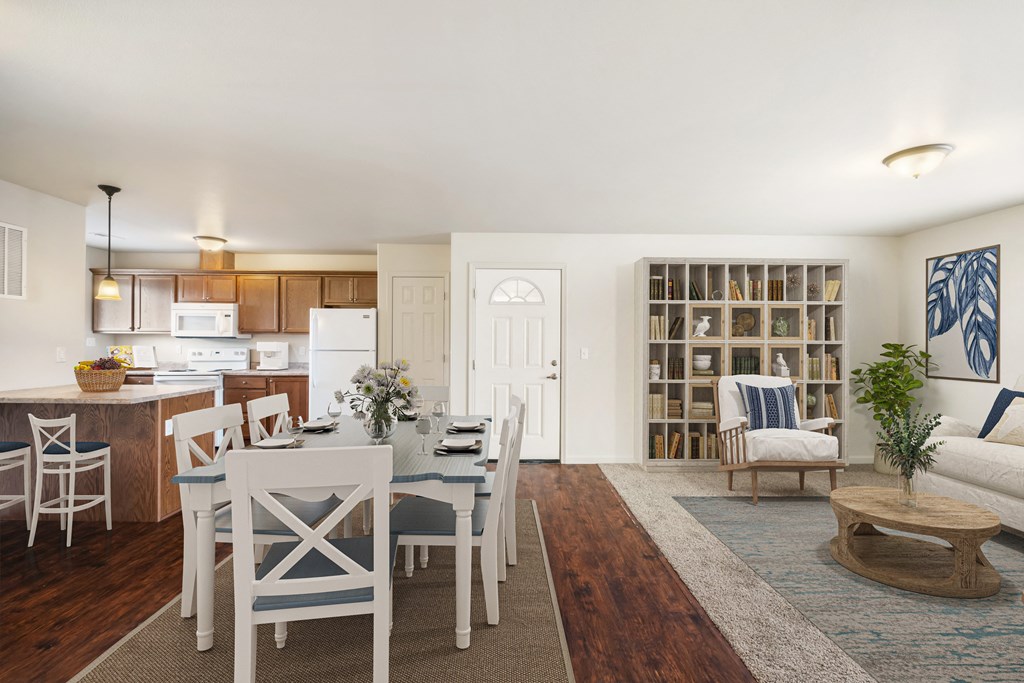 Open layout dining area looking into the kitchen. Wood-style flooring, light-filled windows, and kitchen bar seating. at Pine Tree Park, Washington, 99337