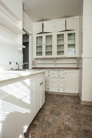 Kitchen with a sink, lots of counterspace and glass panel cabinet doors. - Photo Gallery 3