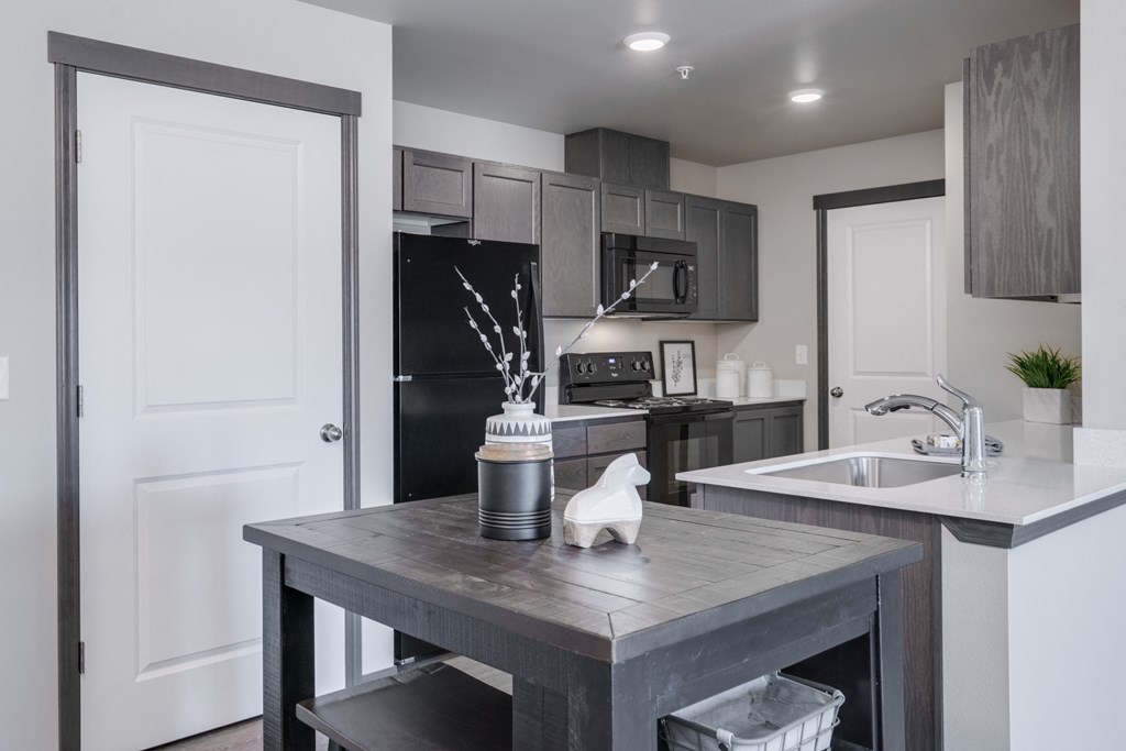 Dining area looking into Kitchen. Dining area has a small bar stool table and chairs. at Altitude, East Wenatchee, WA