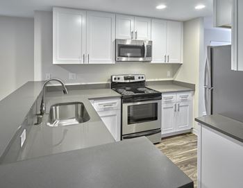 an empty kitchen with white cabi  at Edmonds Gateway, Edmonds, WA, 98026nets and stainless steel appliances