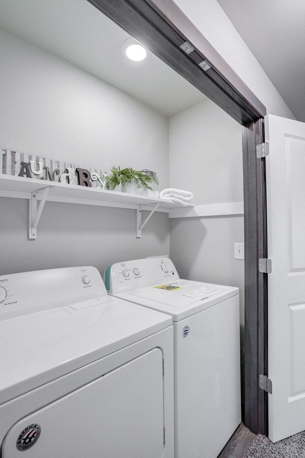 Closet with side by side full sized washer and dryer and upper storage. at Altitude, East Wenatchee, 98802