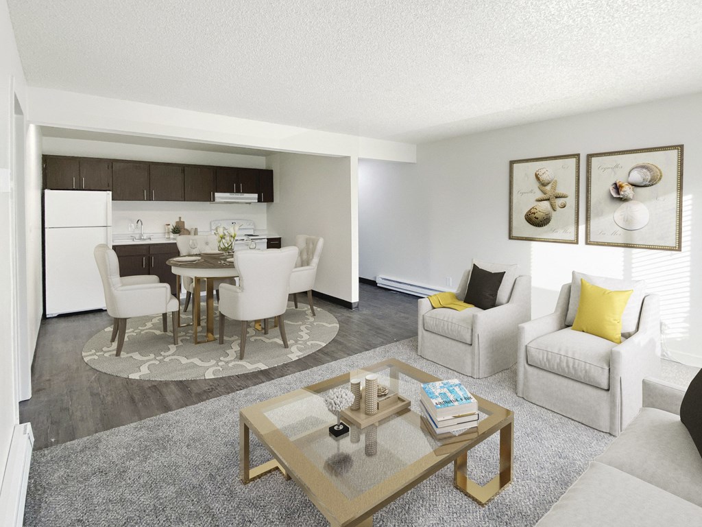 Living room opens into dining area and galley-style kitchen. Staged with dining set, 2 chairs, couch, coffee table.at Laurel Park, Twin Falls