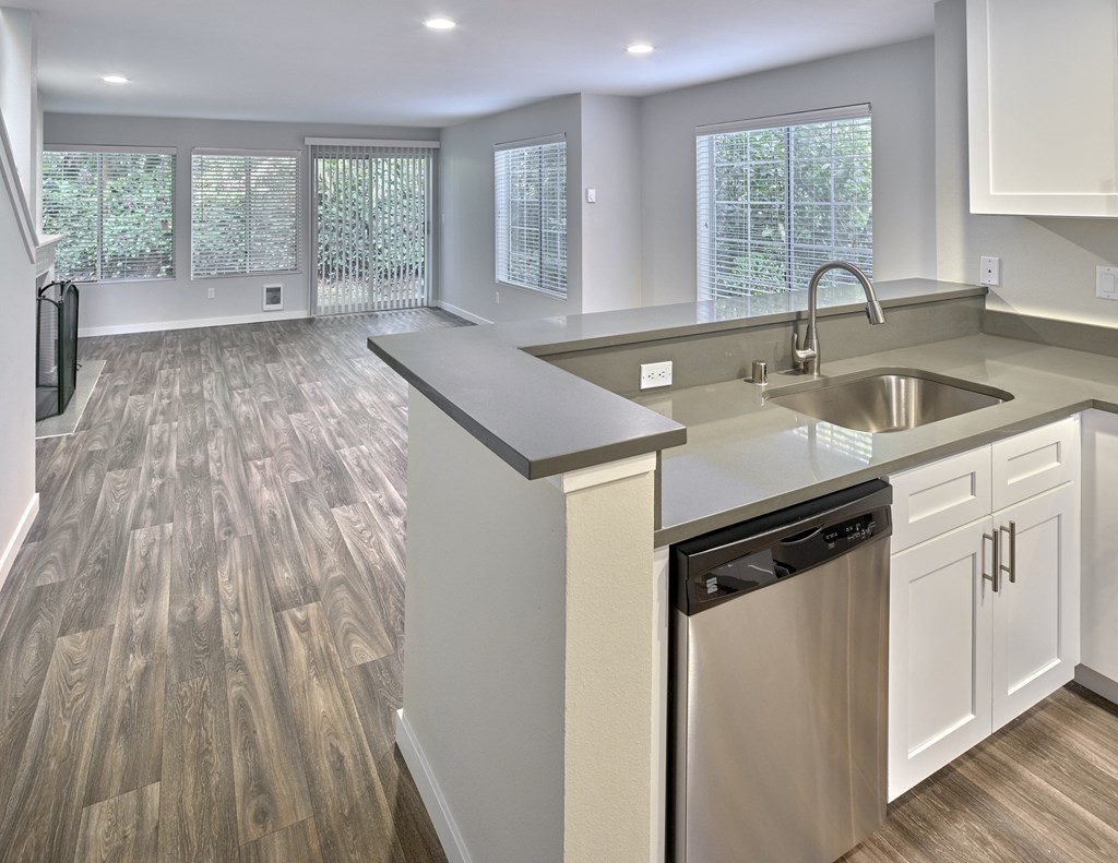an empty kitchen and living room with a sink and dishwasher at Edmonds Gateway, Washington, 98026