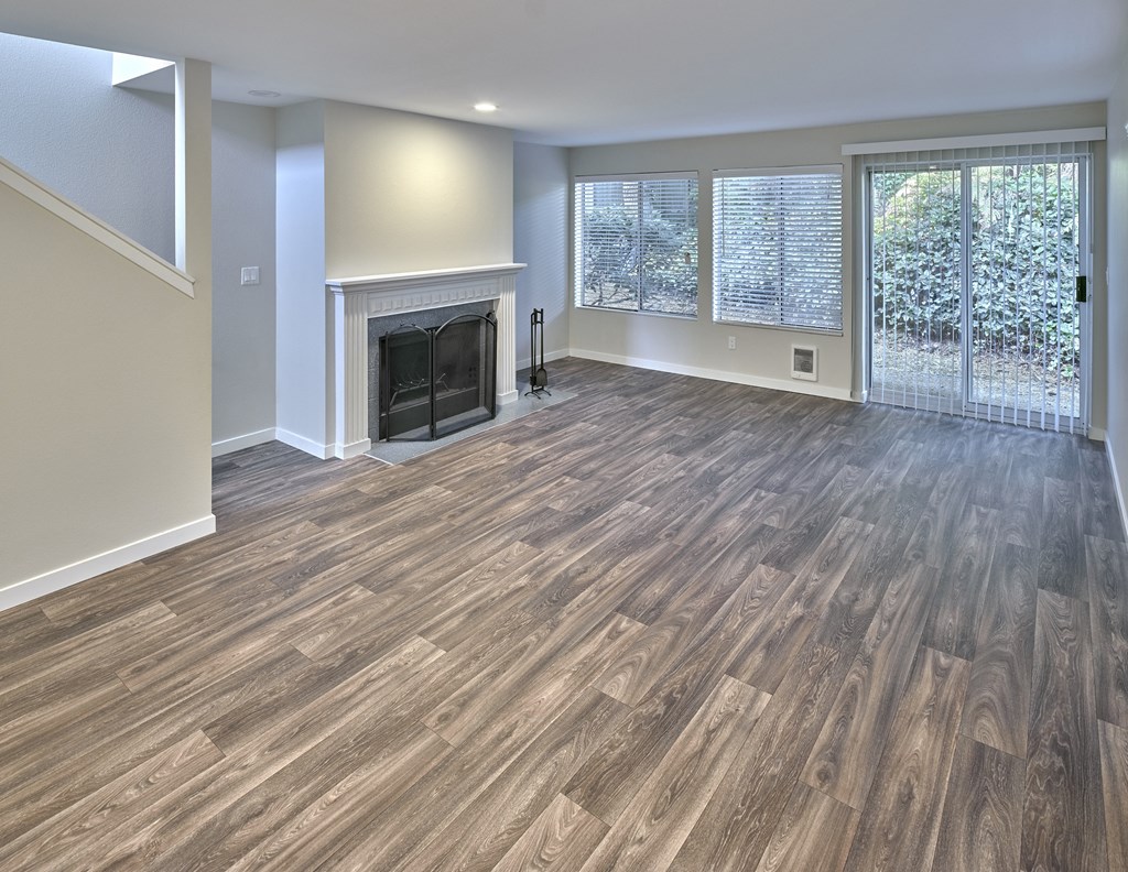 a living room with a fireplace and wooden floors at Edmonds Gateway, Edmonds Washington