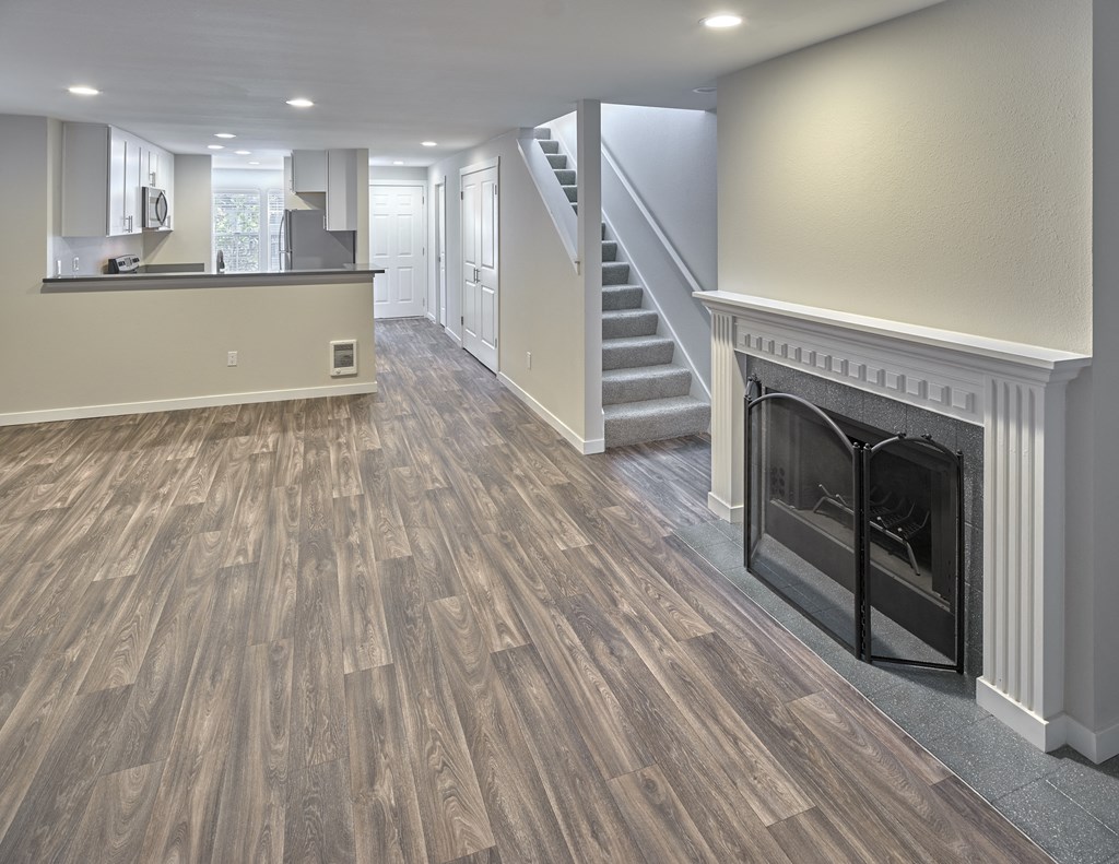 a living room with a fireplace and a staircase at Edmonds Gateway, Edmonds, 98026