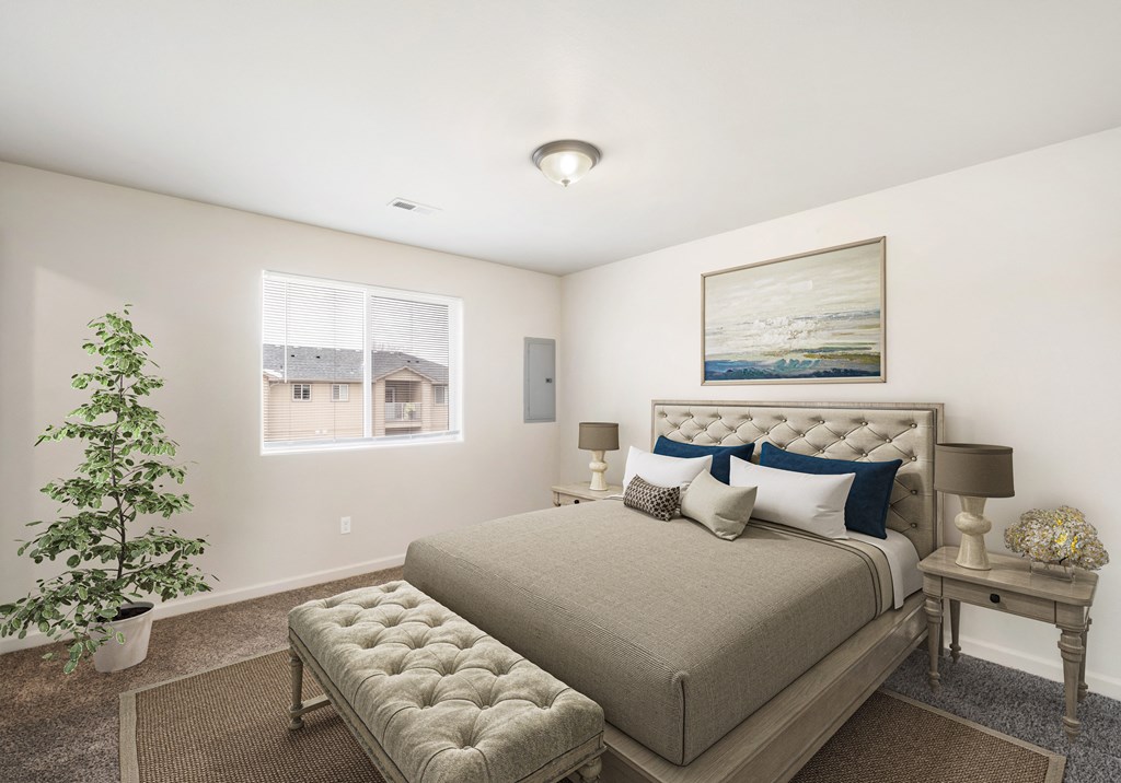 Bedroom Carpeted bedroom with large double window, staged with queen-size bed, side tables, lamps, and a rug. at Pine Tree Park, Kennewick, 99337
