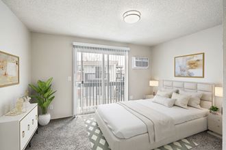 A bedroom with large sliding doors to a private balcony. Staged with a queen-size bed, 2 side tables, a dresser, and wall art.at Wildflower, Kennewick, 99336