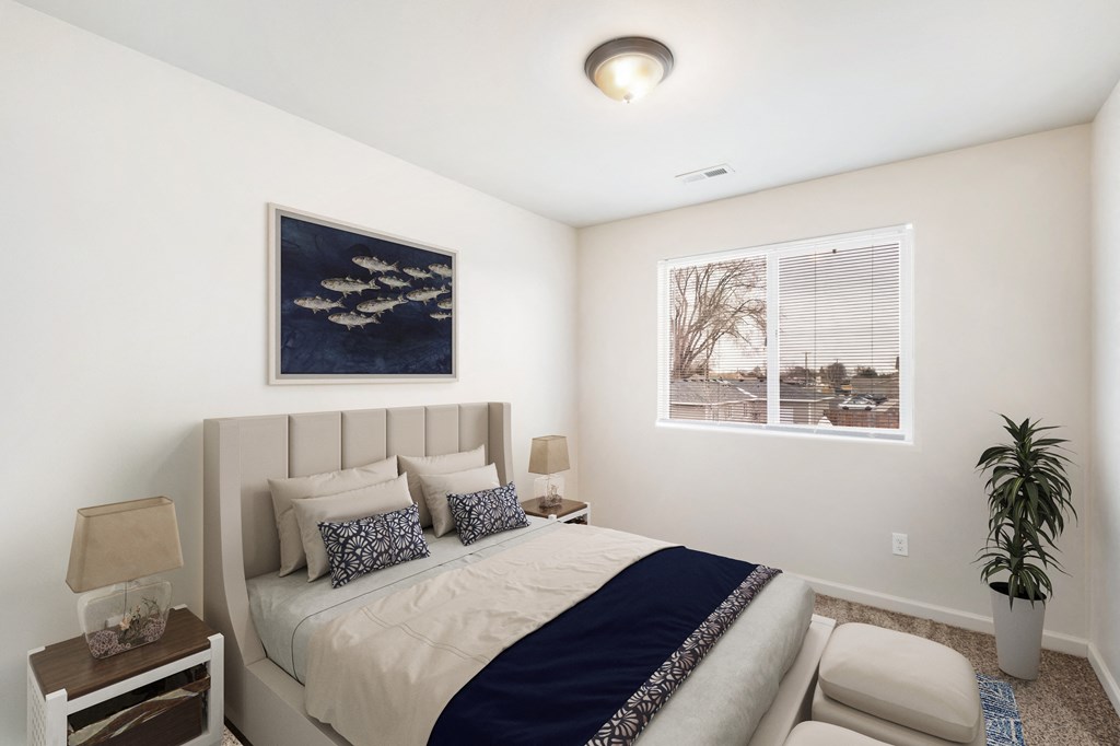 Bedroom with gray carpets, a large window with blinds on the right wall. Staged with bed, side tables, art, and house plant. at Pine Tree Park, Washington