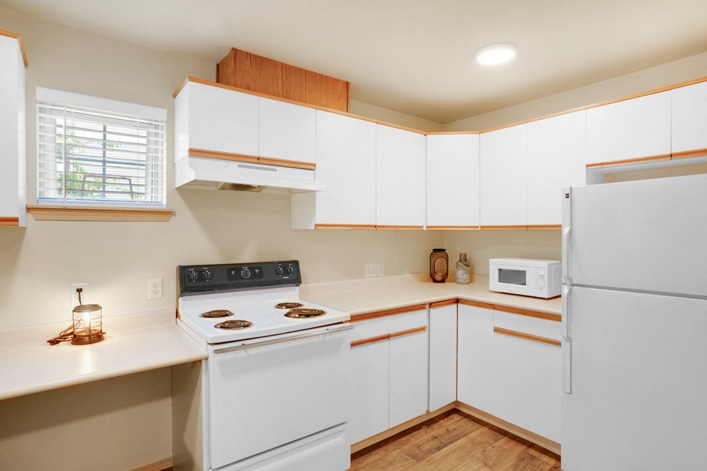 a kitchen with white cabinets and a white stove and white refrigerator at Sky Vue, Bellingham, 98229