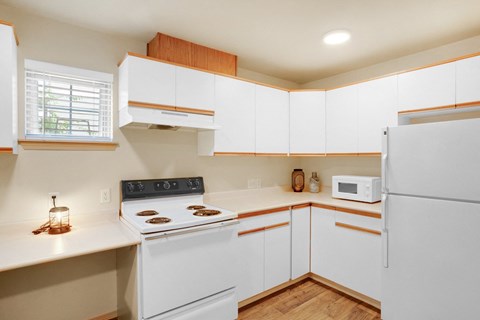 a kitchen with white cabinets and a white stove and white refrigerator at Sky Vue, Bellingham, 98229