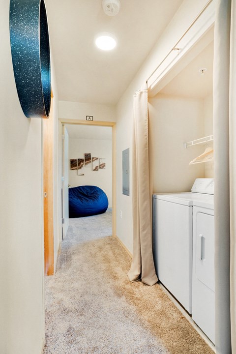 a washer and dryer in a room with a closet and a bed at Sky Vue, Washington
