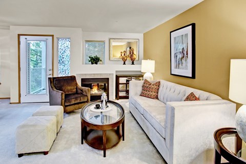 A living room with a white couch and a coffee table.