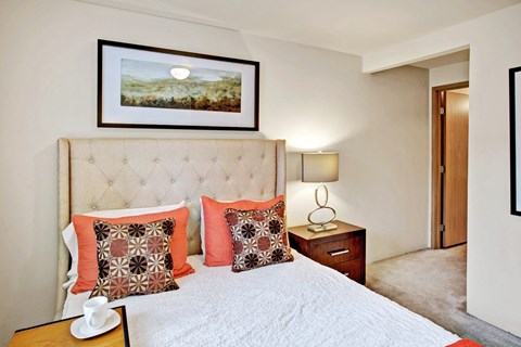 Bedroom with upholstered headboard at Sunrise Lane Apartments Everett WA