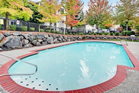 Small outdoor pool with red trim at Sunrise Lane Apartments Everett WA