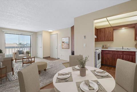 Open dining area with four-seat table next to the living room in a 2 bed 1 bath floor plan at the Lakes in Moses Lake
