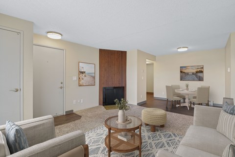 Living room with fireplace and adjoining dining area in a 2 bedroom apartment at The Lakes in Moses Lake, WA